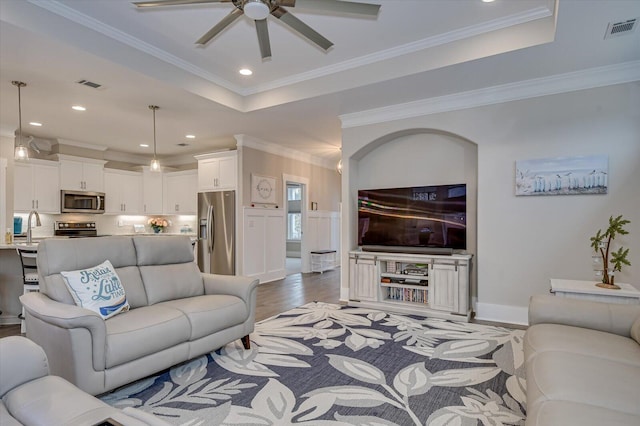 248 Amelia Dr, Mccormick, SC 29835 - living area with a tray ceiling, ornamental molding, a ceiling fan, and visible vents