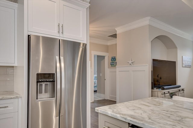 248 Amelia Dr, Mccormick, SC 29835 - kitchen with ornamental molding, white cabinetry, stainless steel refrigerator with ice dispenser, and light stone counters