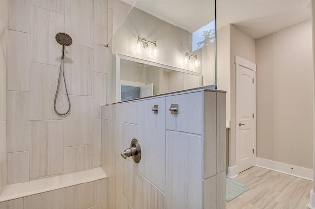 248 Amelia Dr, Mccormick, SC 29835 - bathroom featuring baseboards, a tile shower, and wood finished floors
