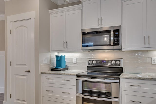 248 Amelia Dr, Mccormick, SC 29835 - kitchen featuring tasteful backsplash, white cabinets, appliances with stainless steel finishes, and light stone countertops