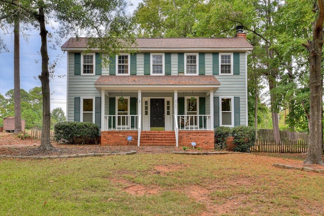 colonial home with a front lawn and a porch