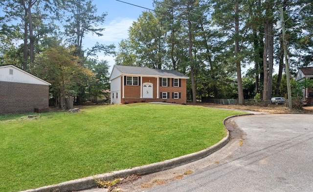 raised ranch featuring a front lawn