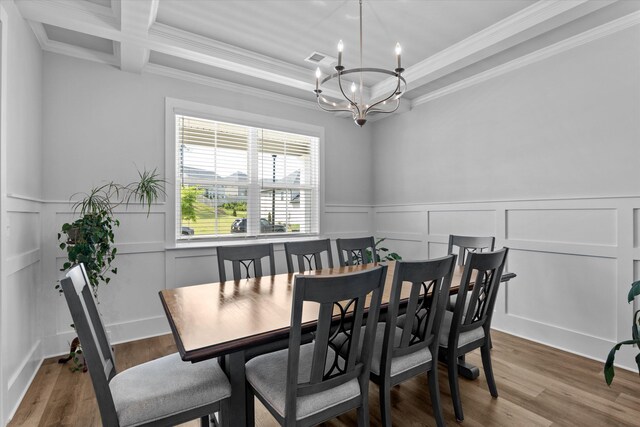 3540 Hilltop Trl, Evans, GA 30809 - dining space with a chandelier, crown molding, wood finished floors, a decorative wall, and a wainscoted wall