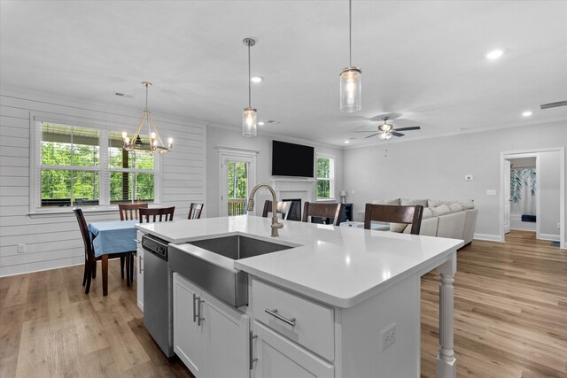 3540 Hilltop Trl, Evans, GA 30809 - kitchen with stainless steel dishwasher, a sink, light countertops, light wood-style flooring, and open floor plan