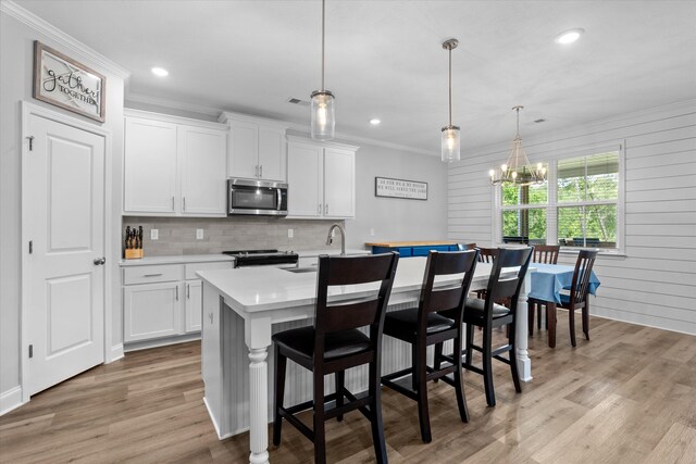 3540 Hilltop Trl, Evans, GA 30809 - kitchen with appliances with stainless steel finishes, light countertops, ornamental molding, a sink, and a kitchen island with sink