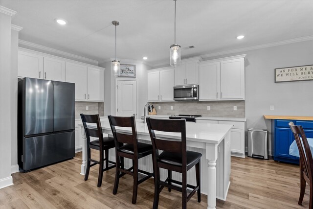 3540 Hilltop Trl, Evans, GA 30809 - kitchen with appliances with stainless steel finishes, light countertops, crown molding, white cabinets, and decorative backsplash