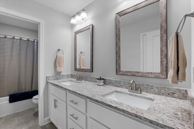3540 Hilltop Trl, Evans, GA 30809 - bathroom featuring double vanity, toilet, and shower / tub combo with curtain