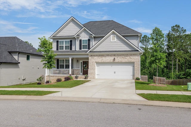 3540 Hilltop Trl, Evans, GA 30809 - craftsman-style home featuring a porch, concrete driveway, brick siding, and a shingled roof