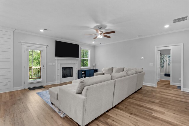 3540 Hilltop Trl, Evans, GA 30809 - living area featuring ceiling fan, light wood-style flooring, a glass covered fireplace, ornamental molding, and recessed lighting