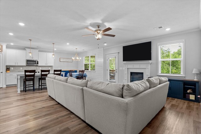 3540 Hilltop Trl, Evans, GA 30809 - living room with crown molding, plenty of natural light, ceiling fan, light wood-type flooring, and recessed lighting