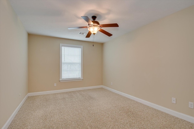 carpeted empty room featuring ceiling fan and baseboards