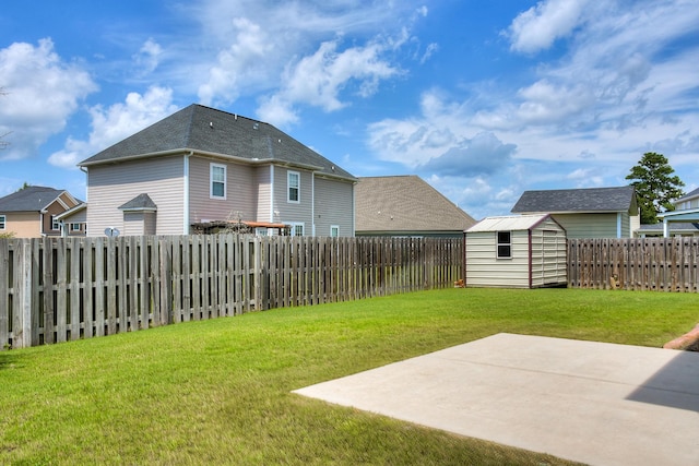view of yard featuring a patio, a storage unit, and an outdoor structure