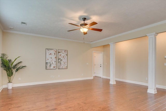 spare room featuring decorative columns, light wood-style flooring, ceiling fan, ornamental molding, and baseboards
