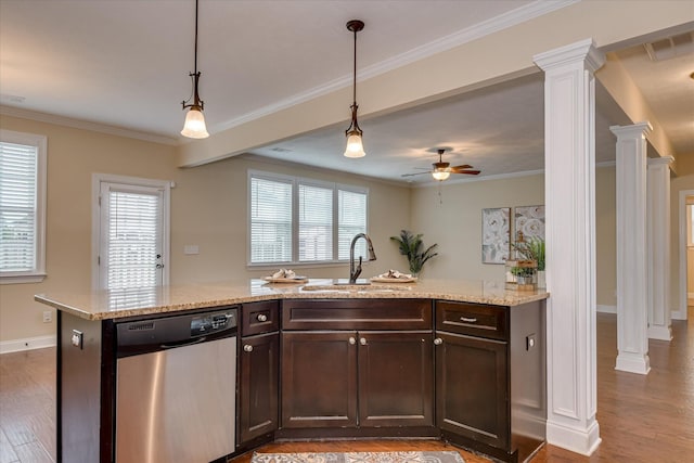kitchen featuring dishwasher, ornate columns, a sink, dark brown cabinetry, and crown molding