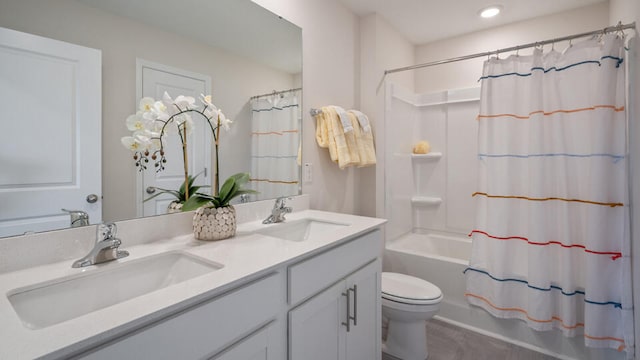 full bathroom featuring double vanity, a sink, toilet, and shower / tub combo with curtain