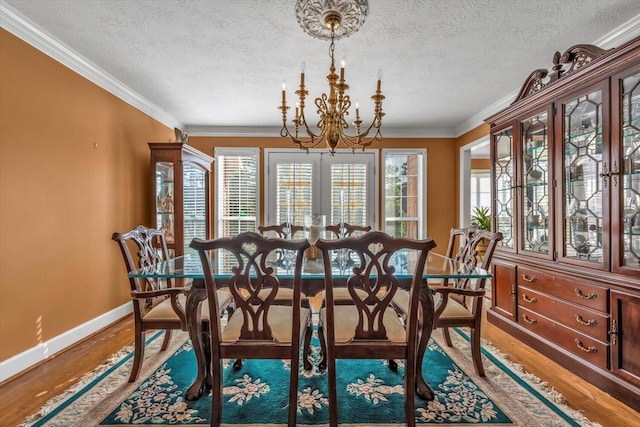 3974 Bolton St, Augusta, GA 30909 - dining room featuring a chandelier, baseboards, wood finished floors, ornamental molding, and a textured ceiling
