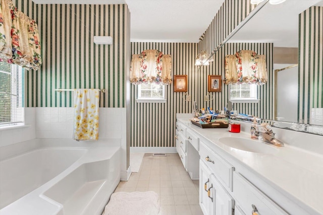 3974 Bolton St, Augusta, GA 30909 - bathroom featuring wallpapered walls, plenty of natural light, double vanity, a garden tub, and baseboards