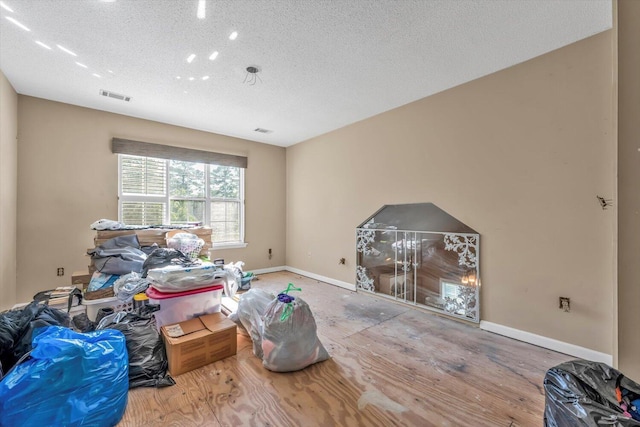3974 Bolton St, Augusta, GA 30909 - living room with wood finished floors, baseboards, and a textured ceiling