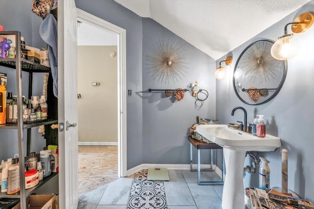 3974 Bolton St, Augusta, GA 30909 - bathroom featuring lofted ceiling, a textured ceiling, and baseboards