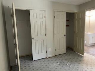 4512 Country Glen Cir, Grovetown, GA 30813 - unfurnished bedroom featuring tile patterned floors and connected bathroom