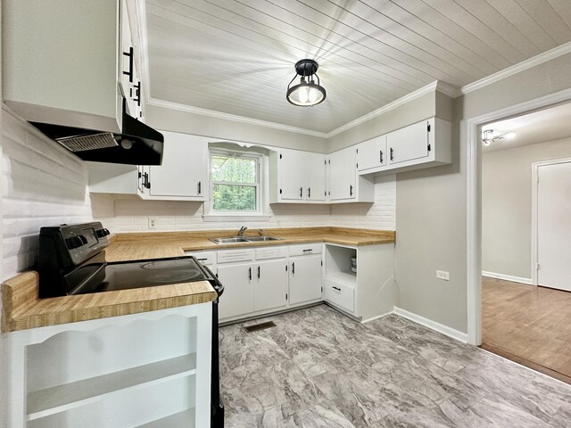 kitchen featuring white cabinets, crown molding, butcher block counters, and sink