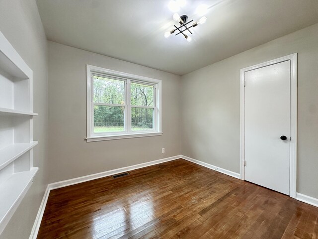 empty room with hardwood / wood-style flooring