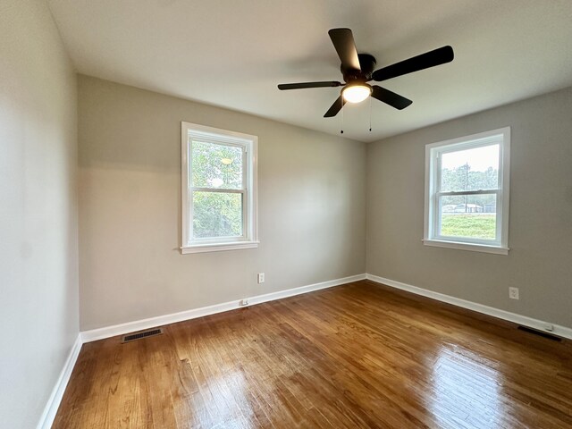 spare room with hardwood / wood-style floors, plenty of natural light, and ceiling fan