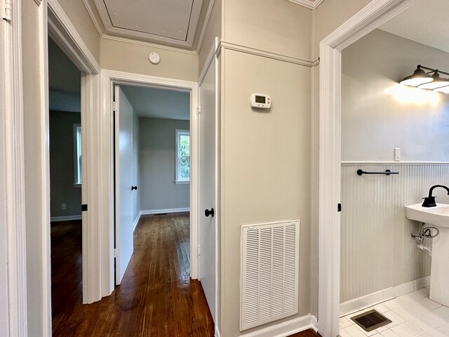 bathroom featuring hardwood / wood-style flooring and ornamental molding