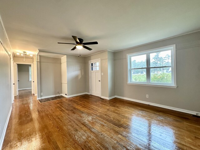 spare room featuring ceiling fan, hardwood / wood-style floors, and crown molding