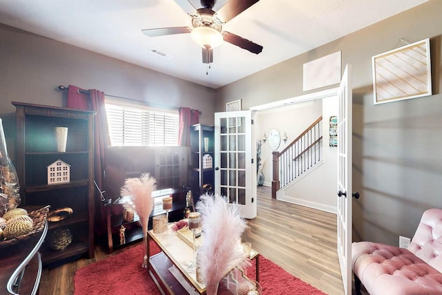 living room with hardwood / wood-style flooring and ceiling fan