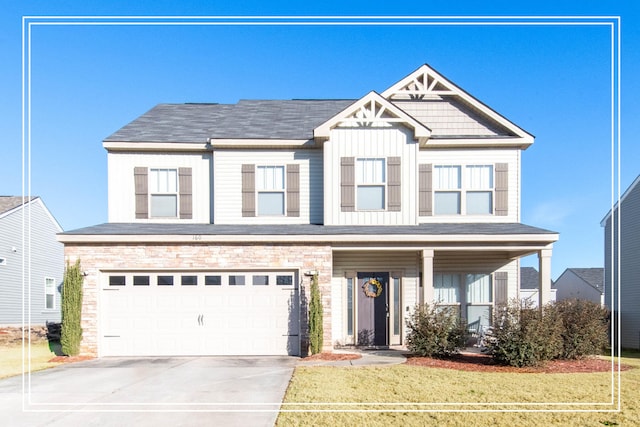 view of front of home with a front yard and a garage