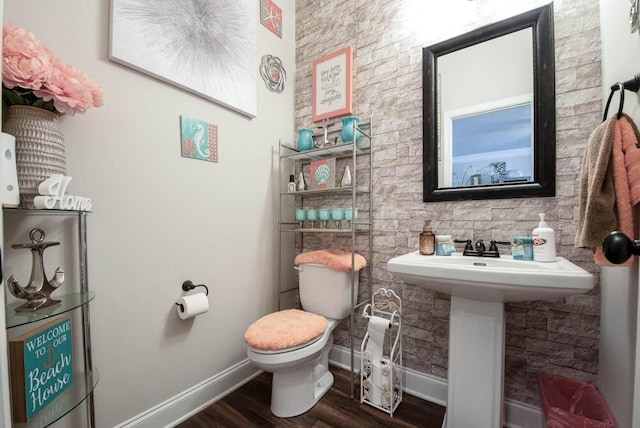 bathroom with toilet, wood-type flooring, and sink