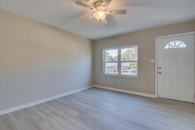 foyer with ceiling fan, light wood-style flooring, and baseboards