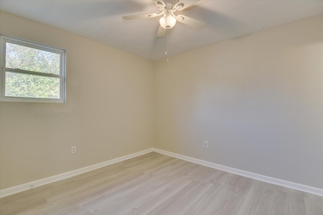 unfurnished room with light wood finished floors, a ceiling fan, and baseboards