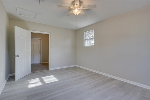 interior space featuring baseboards, attic access, and light wood-style floors