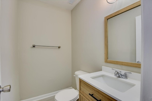 bathroom with toilet and vanity