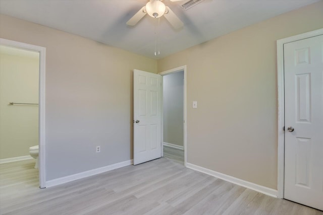 unfurnished bedroom with light wood-style floors, a ceiling fan, visible vents, and baseboards