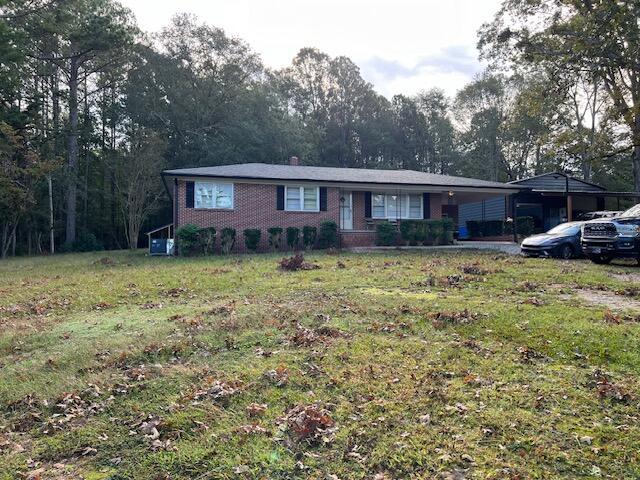 ranch-style home with a carport