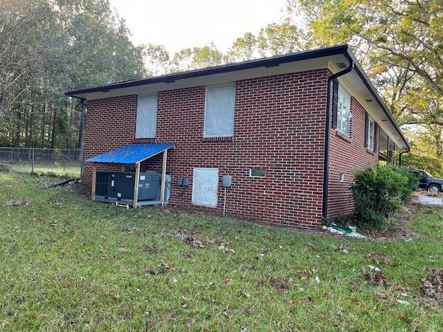 view of side of property with a yard