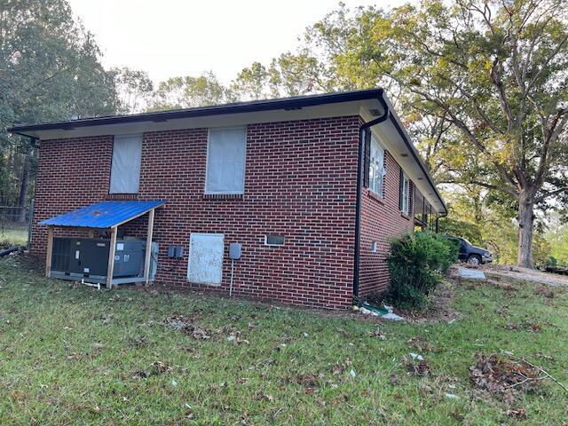 view of side of home featuring a lawn