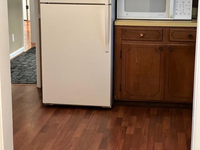 details featuring white appliances and dark hardwood / wood-style floors