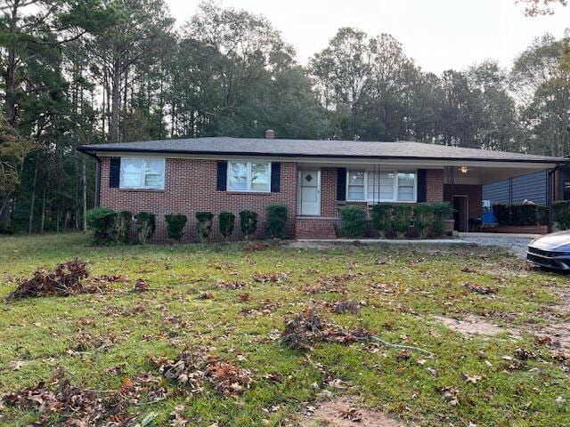 single story home featuring a front yard and a carport