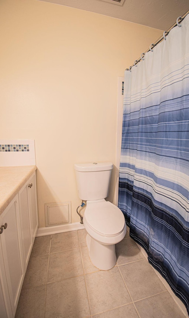 bathroom featuring radiator heating unit, vanity, curtained shower, tile patterned floors, and toilet