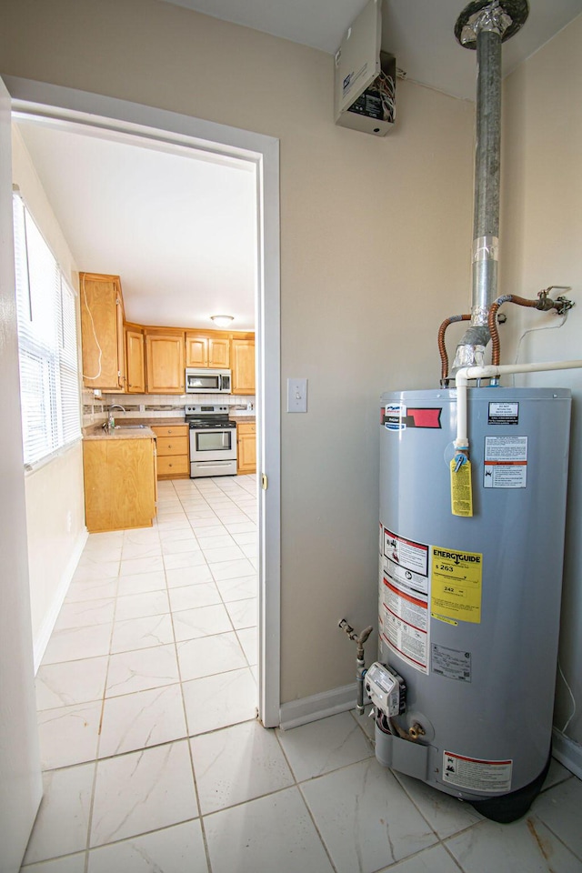 utility room featuring sink and gas water heater