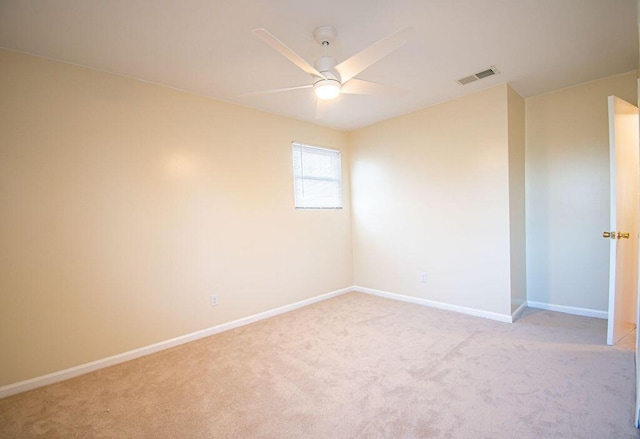 spare room with light carpet and ceiling fan