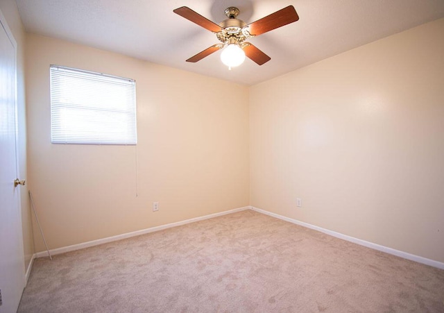 spare room featuring light carpet and ceiling fan