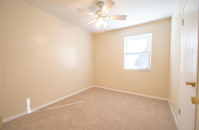 spare room featuring ceiling fan and light colored carpet