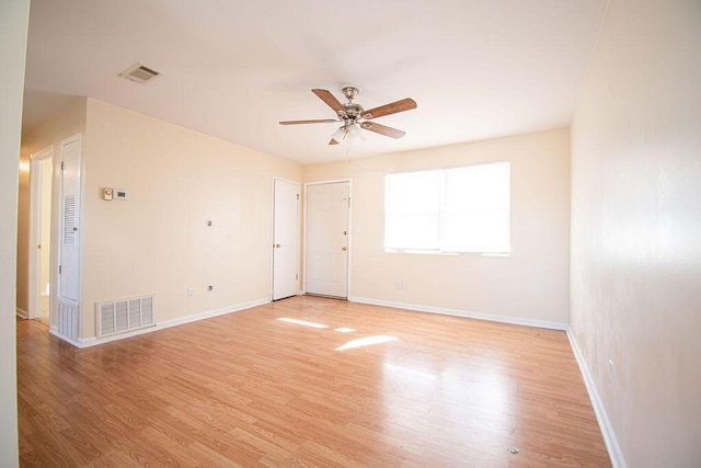 spare room with ceiling fan and light wood-type flooring