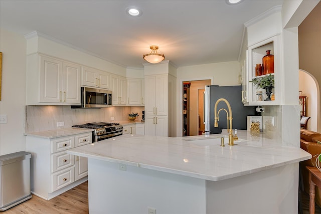 267 Fairway Dr, Mccormick, SC 29835 - kitchen featuring stainless steel appliances, a sink, a peninsula, white cabinetry, and light wood-style floors