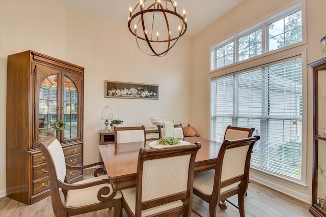 267 Fairway Dr, Mccormick, SC 29835 - dining space with a chandelier, light wood-style flooring, baseboards, and a high ceiling